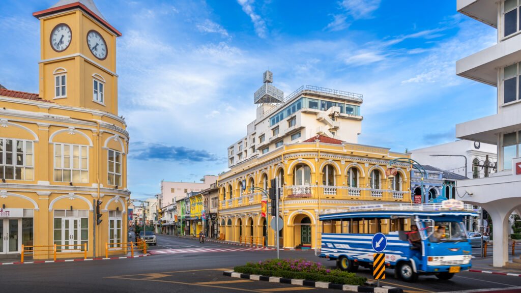 Yellow historic buildings and a blue bus in Phuket Old Town